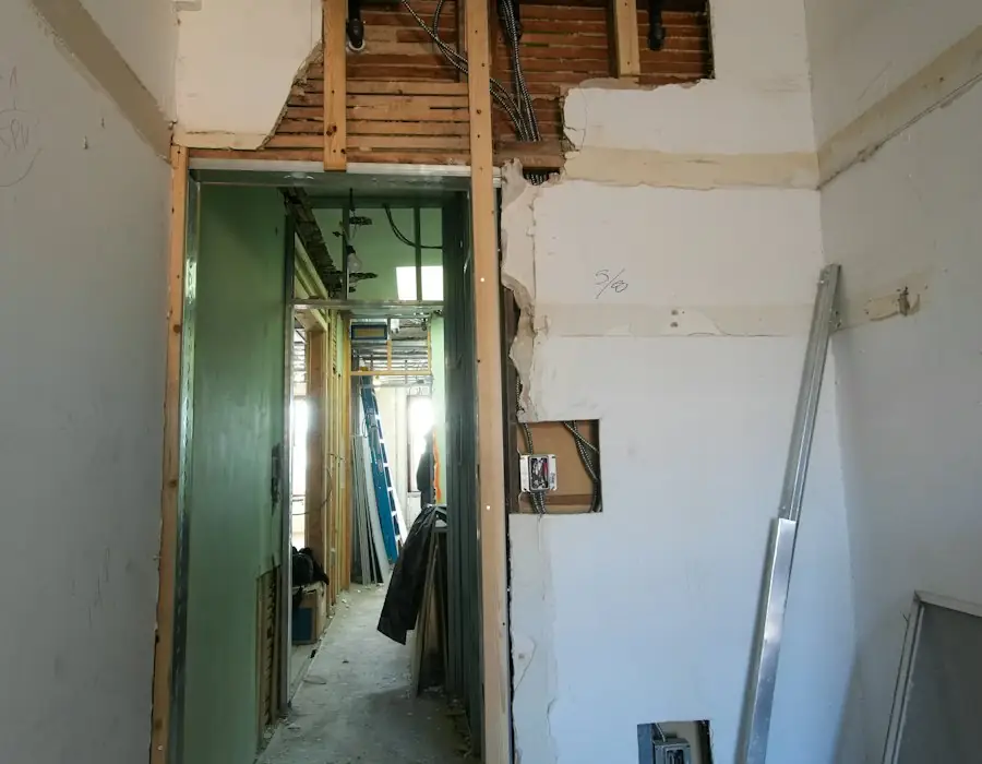 Room with walls stripped during reinstatement