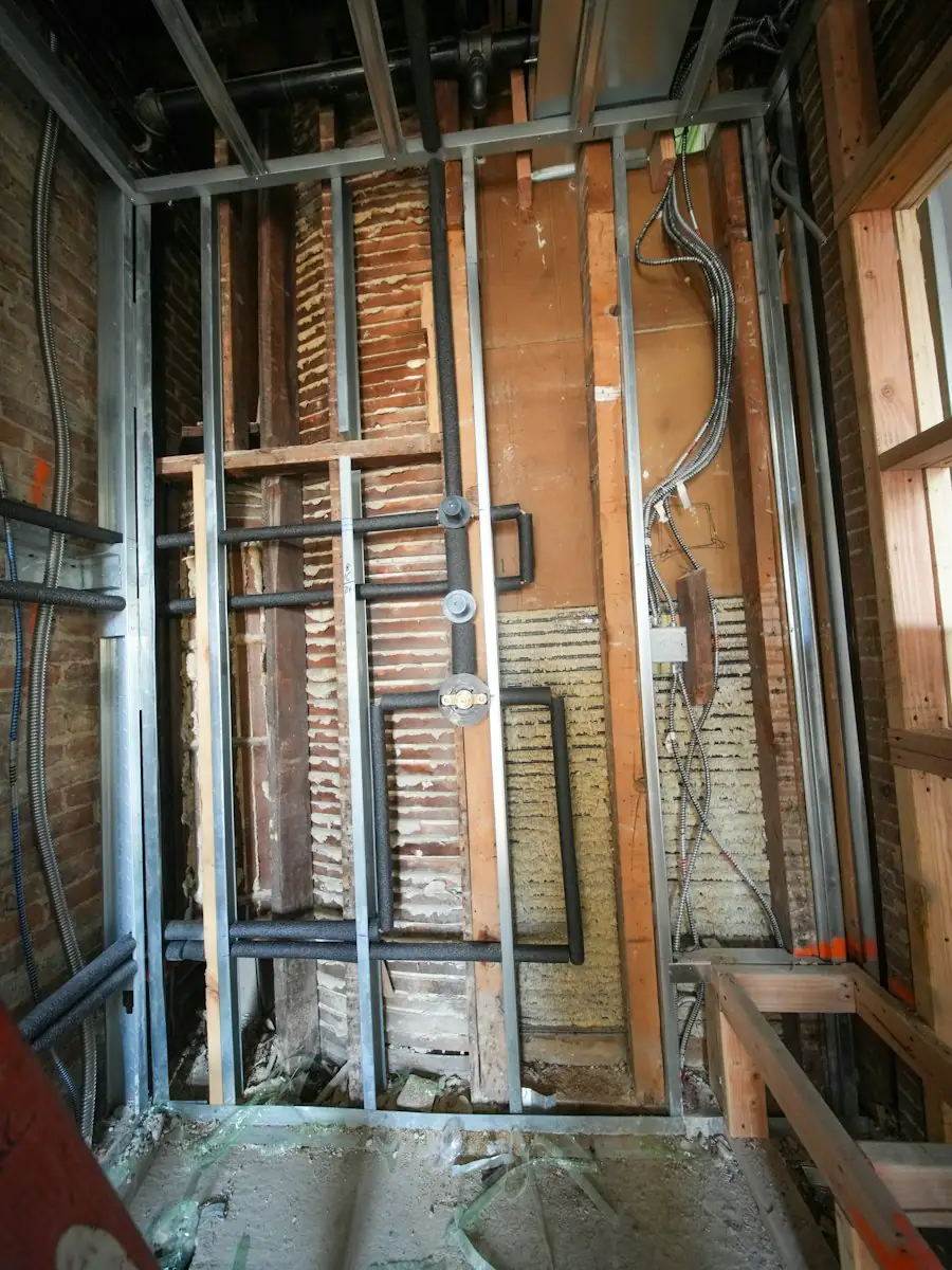 Exposed pipes and wiring after strip-out