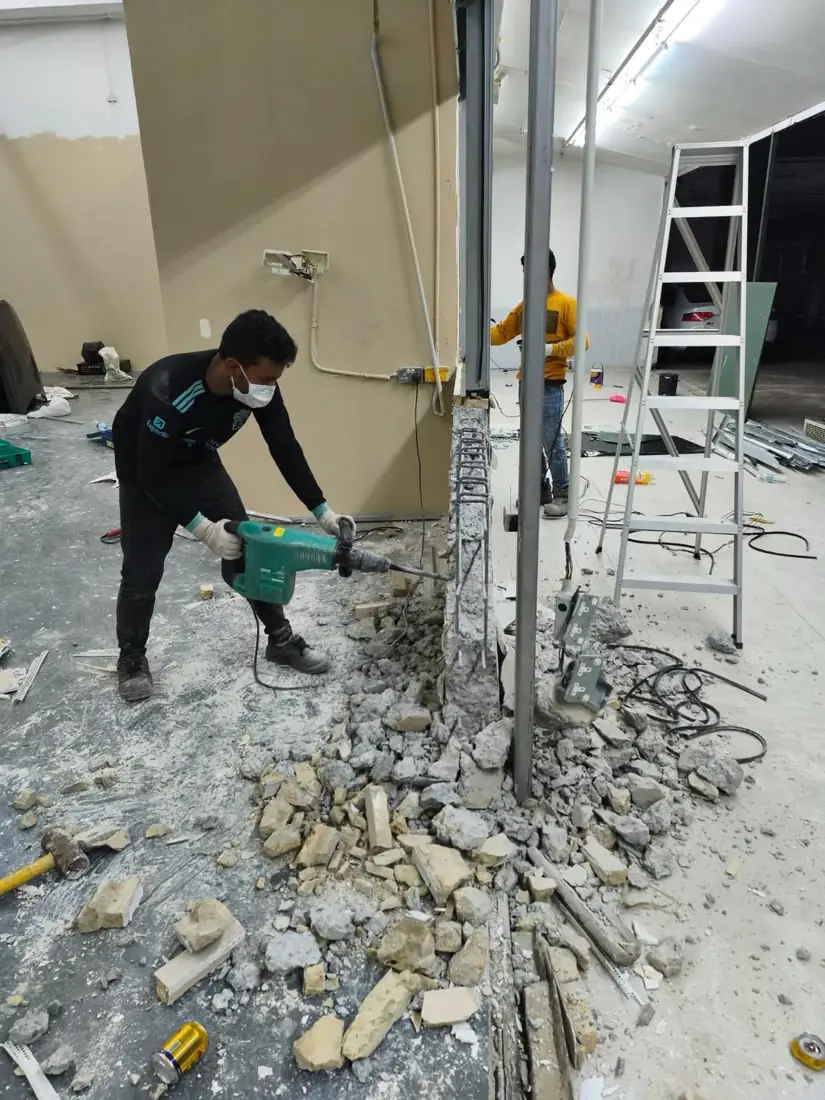 Our worker hacking a wall with a jackhammer